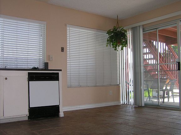 Kitchen towards dining room and wall to wall sliding door towards back yard