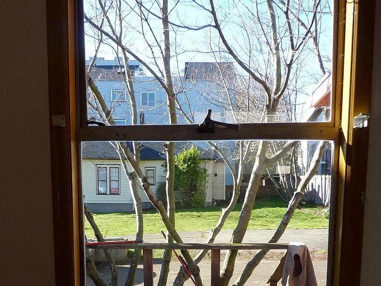 View from kitchen to neighboring empty lot and single-family house.