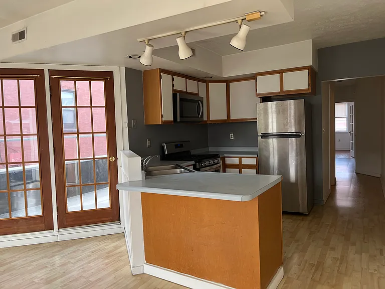 Kitchen with Stove, Above Stove Microwave, Dishwasher, Refrigerator, Bar Overhang Counter