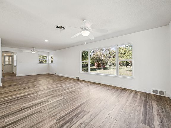 Large spacious living area leading to kitchen