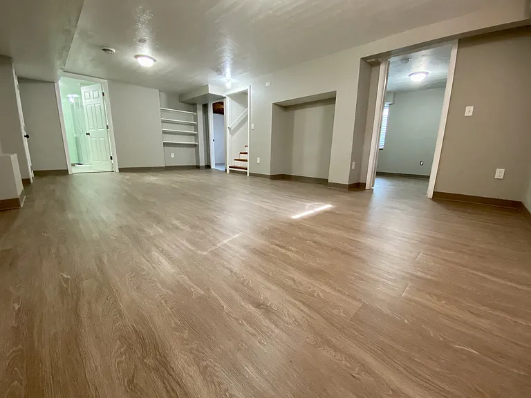 Spacious, modern apartment with elegant wood-style flooring, featuring a bright, open-concept design and convenient built-in shelving. Spacious, modern apartment with elegant wood-style flooring, featuring a bright, open-concept design and convenient buil