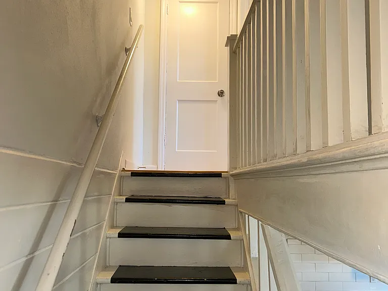 Staircase to upstairs bedroom and hallway closet