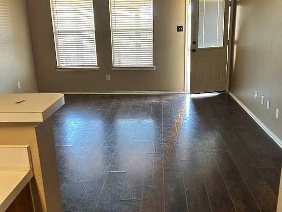 Living room off kitchen. Door to backyard.
