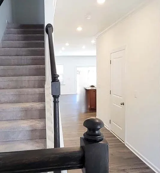 Stairs on the left side of the entrance leading to the bedrooms