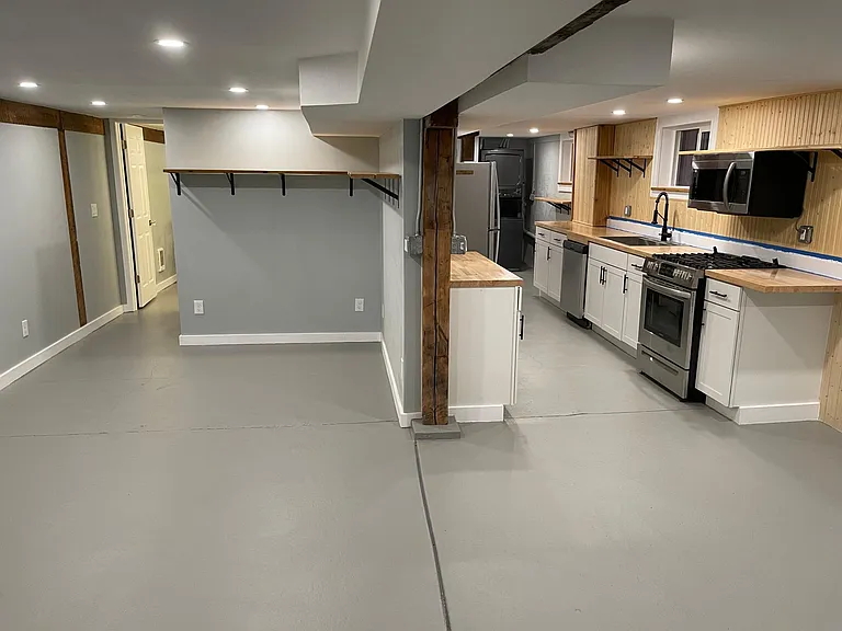 Open living space between the kitchen, living room and bedroom