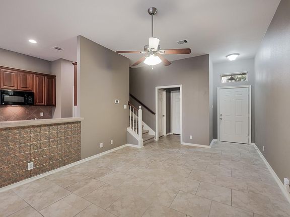 Entryway, 1/2 bath, door to garage, kitchen and stairs.