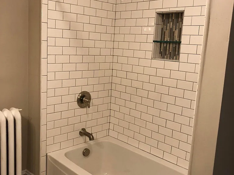 Shower with subway tile and cubbie