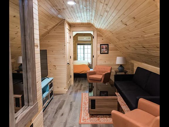 View from top of the spiral stairs to the bedroom. The closet is to the left of the door going into the bedroom. Coffee table is replaced with a traditional wooden coffee table now.