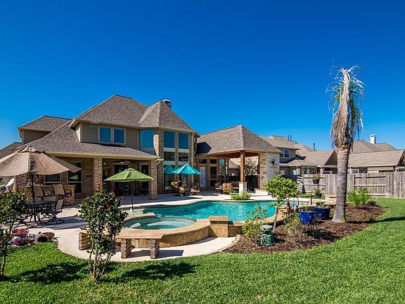 View of your pool and spa, check out the outdoor living area and outdoor kitchen.