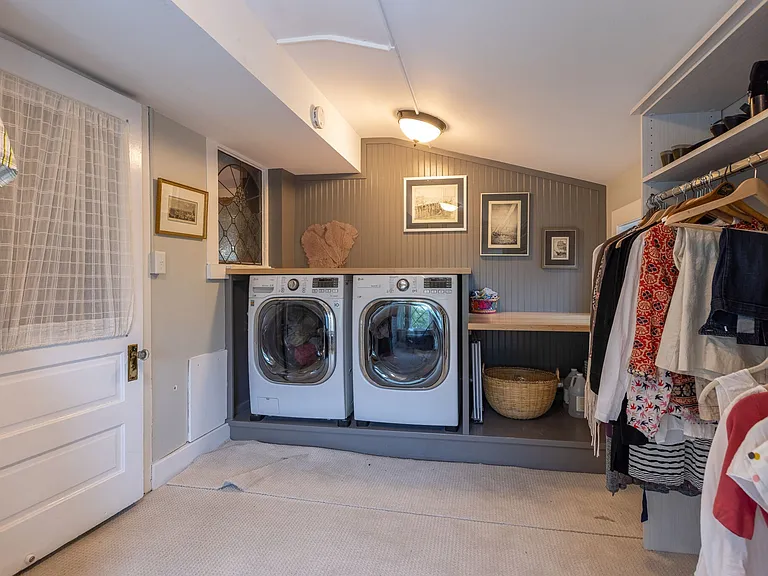 Primary closet includes the home's 2nd laundry room and built-in shelving.