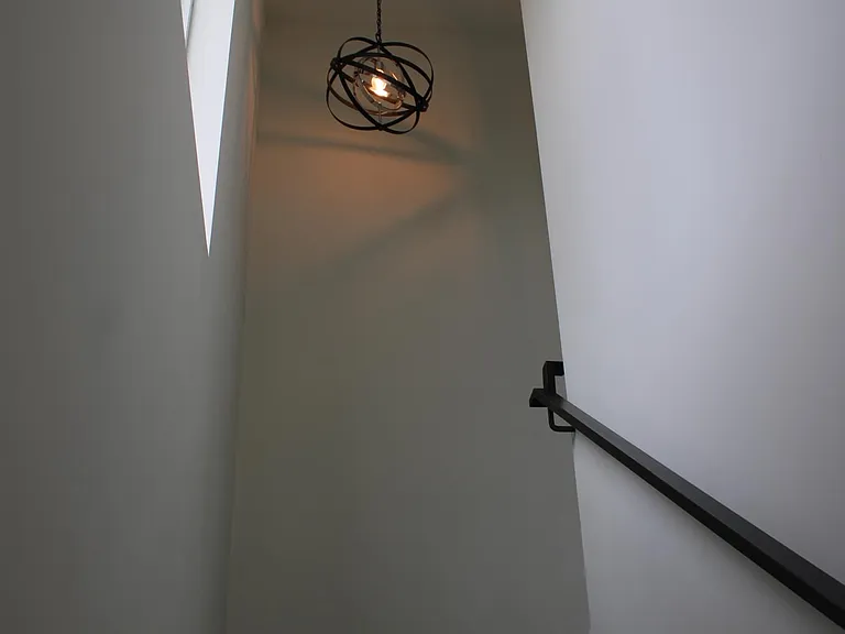 stairs looking up from first floor with landing area following through to the second floor.