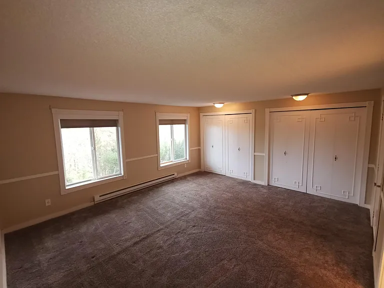 Very large master bedroom, with large closets running length of the room.