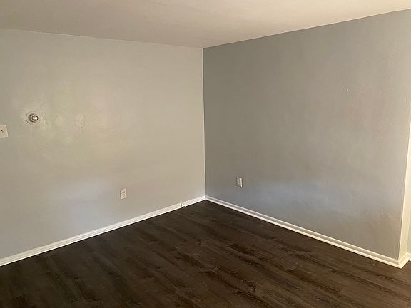 Large living room with front window and new flooring