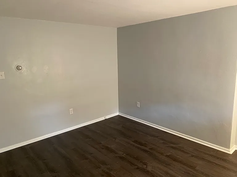 Large living room with front window and new flooring