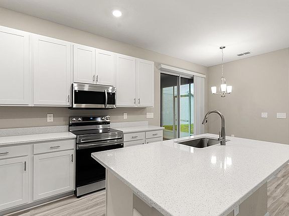 Your well-appointed kitchen includes quartz counters, 42-in cabinets, Samsung SS appliances, and a p