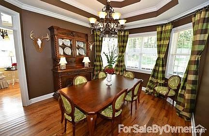 Large living room with beautiful windows : Door provides access to cover porch and large backyard wi