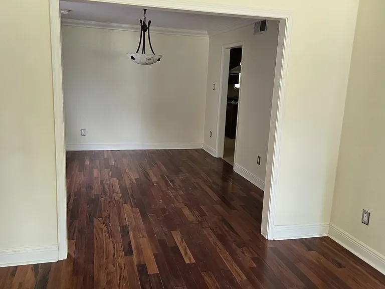 Dining room with hardwood floors connecting to living room on first floor.