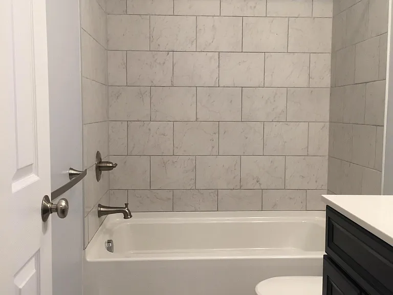 Full Bath with tile shower and flooring