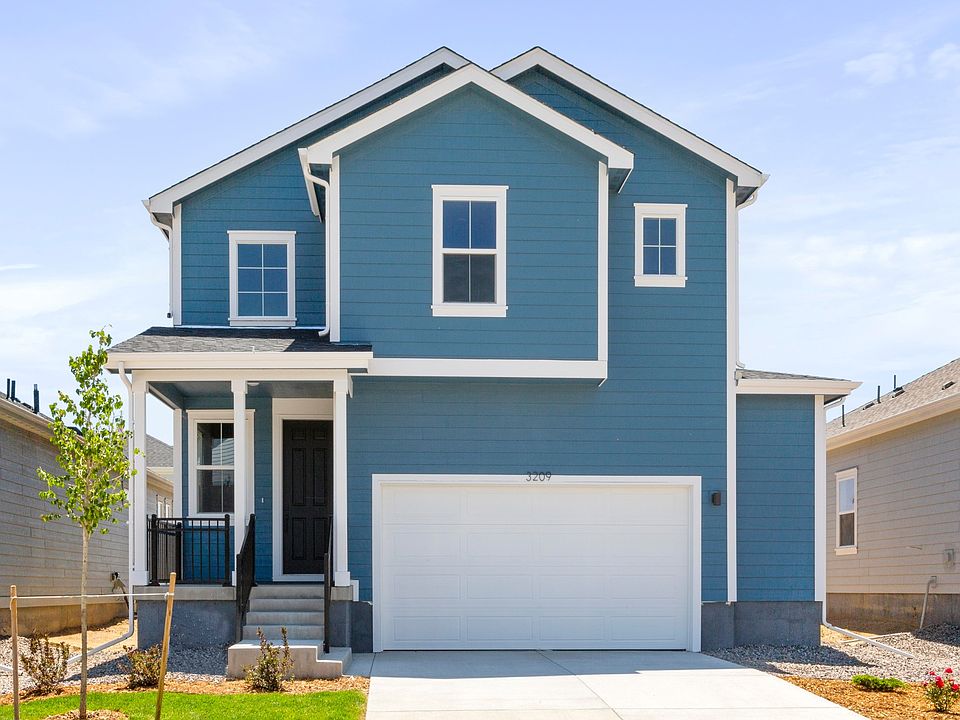Elegant blue facade with gabled roof and white trim. Spacious garage. Perfect spot in a serene neigh