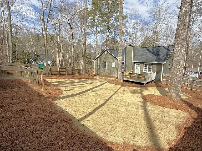 Large fenced in private back yard with deck
