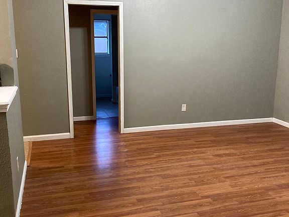 View of hallway bathroom with 2 bedrooms on one side of house.