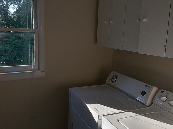 Separate laundry room off kitchen.