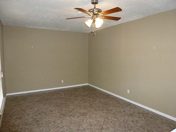 Large living area with ceiling fan and Tile