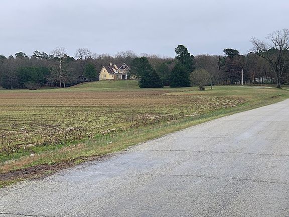 Field on one side , woods on