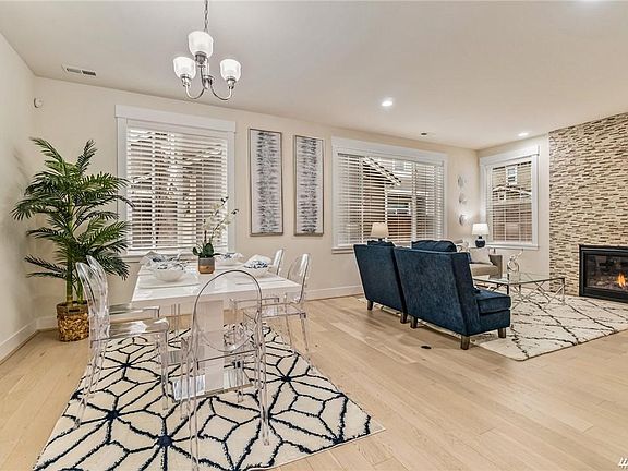 Open dining room and family room with cozy gas fireplace.