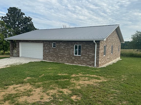 Front and side of all brick house.