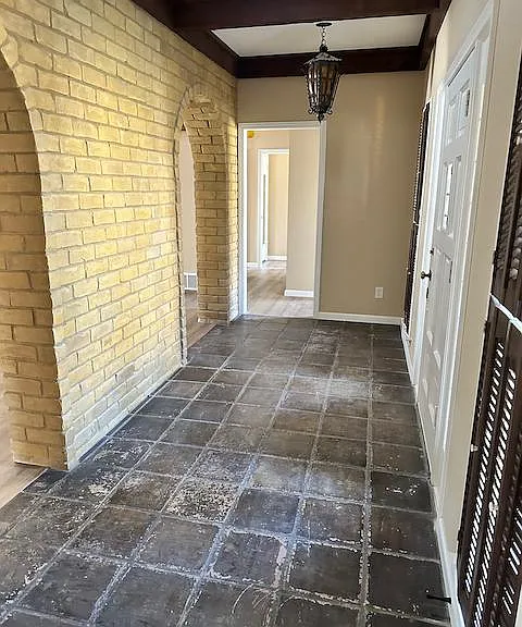 Custom mediterraneantile in entry way lit by newly installed skylight