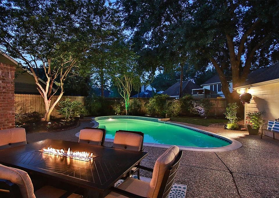 PRIVATE AND PEACEFUL BACKYARD SPOT WITH LARGE POOL AND OVERSIZED DECKING - This lovely back yard has so many entertaining opportunities. Unique colorful lighting system is accessed by remote control and lights the gorgeous mature trees. A private cou