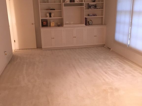 Den with built-in cabinetry 