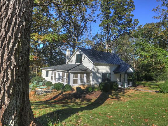 Cottage enjoys a large private yard with a bricked patio for entertaining