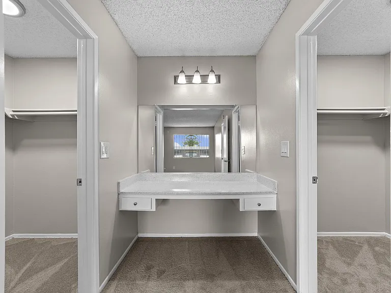 Vanity and double walk-in closets at Strada Apartments in Orange, CA