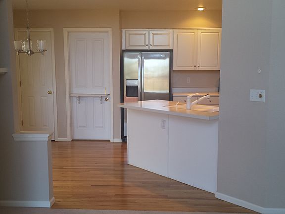 Eat-in kitchen with stainless steel appliances.
