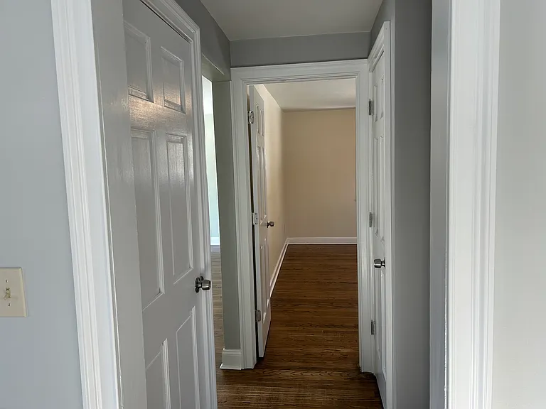 View of main floor bedroom from kitchen and basement door