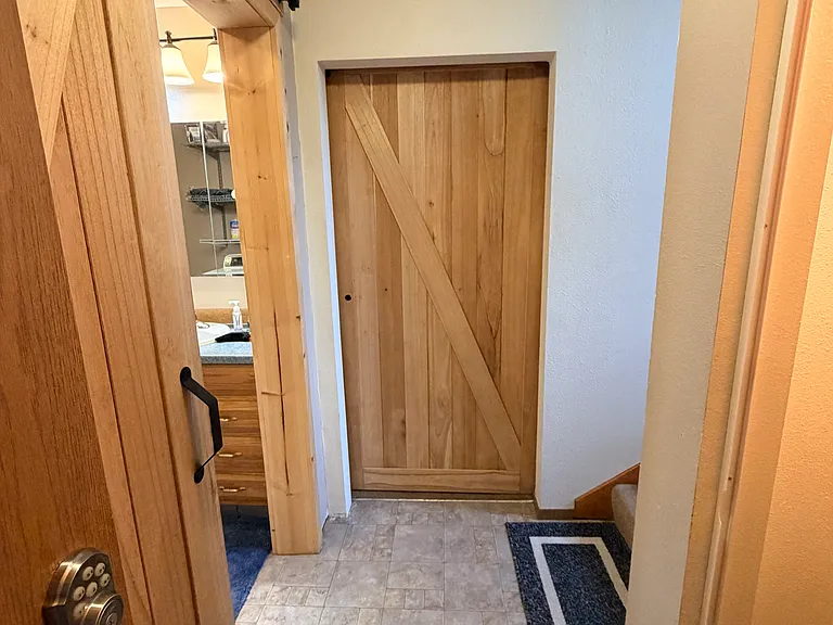 Barn doors to downstairs bedroom bathroom and garage