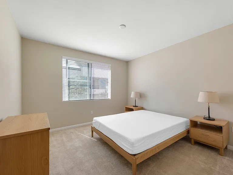Furnished+ apartment homes feature queen bed with mattress, dresser, nightstands, and lamps (Representative Image exact items and style of furnishings may vary)