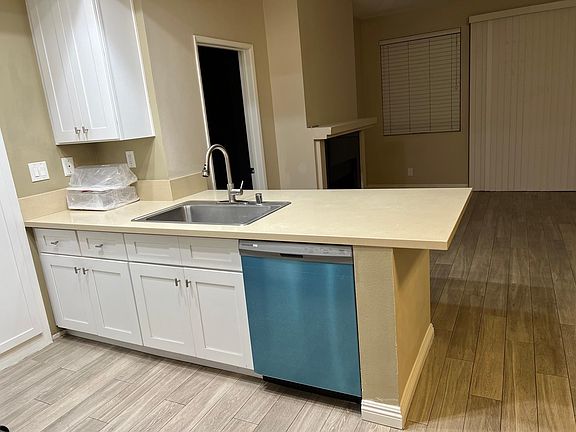 Open-concept kitchen overlooking living room.