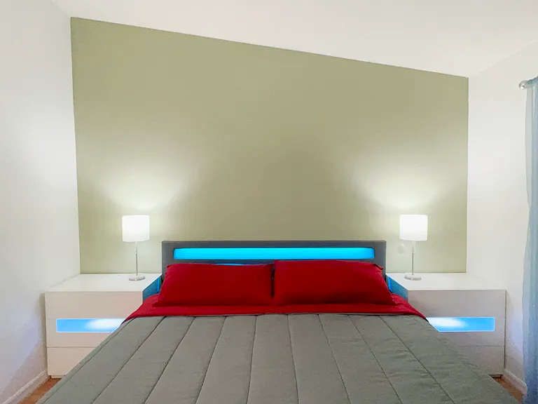 King Size Bed w/ modern night stands and lamps.