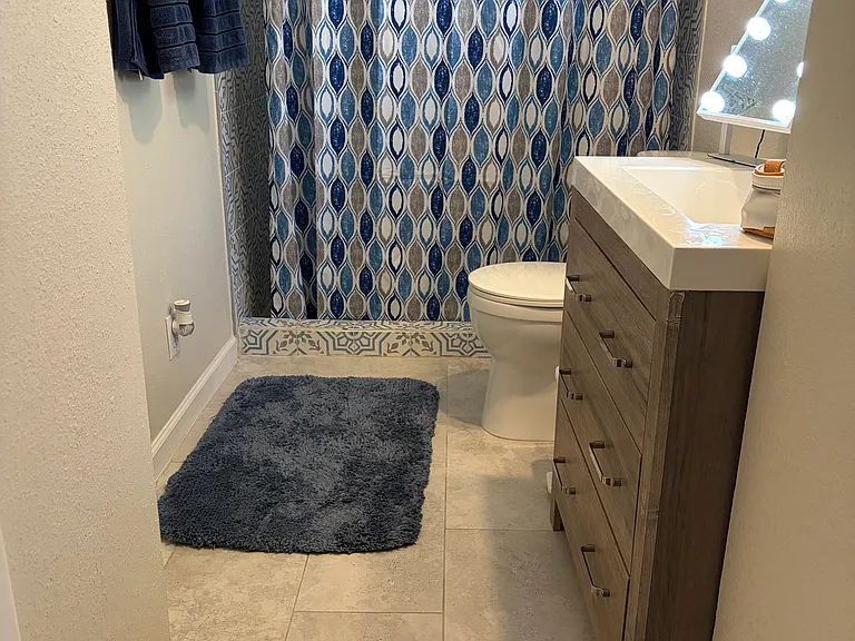 Nice bathroom. Sink vanity has storage.