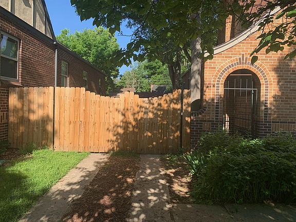 Driveway with parking behind the secure wood gate and decorative wrought iron entrance.