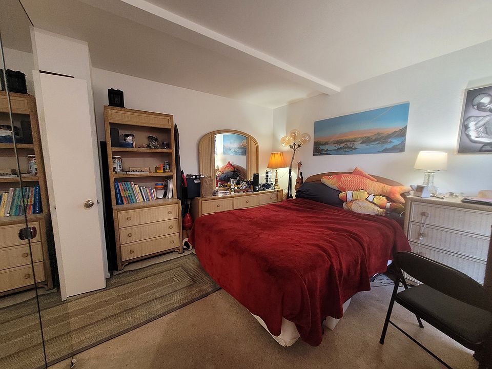 Comfy room with ample closet space, dresser, desk, balcony, and private en-suite bathroom.