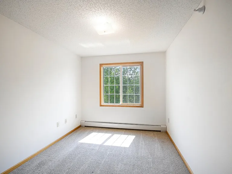 Step into the serene, sunlit spaces of Mill Pond Apartments. This inviting room features large windows that bring in natural light, perfect for creating your personal oasis. Schedule a tour today and imagine your new life here!