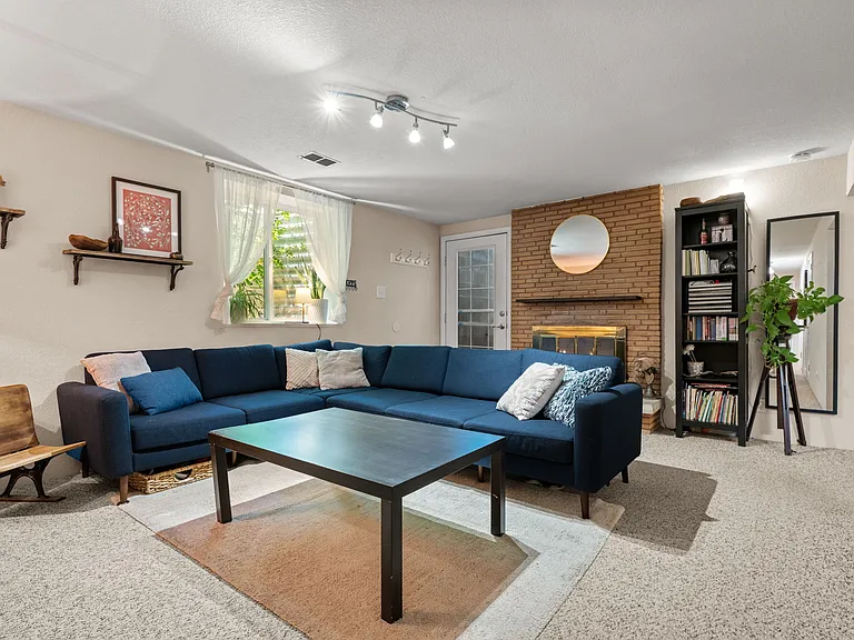 Basement apartment living area with fireplace