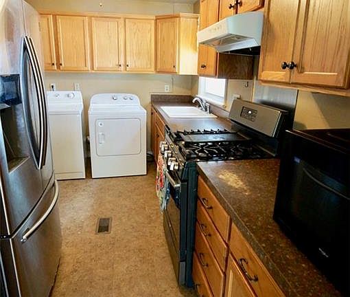 Loads of cabinet space in this beautiful kitchen including stainless steel appliance upgrades and a gas stove.