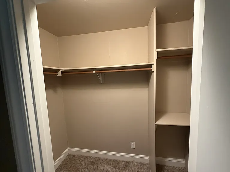 Partial view of master walk in closet