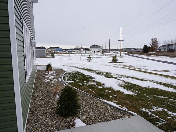 Sliding glass door from the kitchen leads to a patio and backyard that has access to trail system.