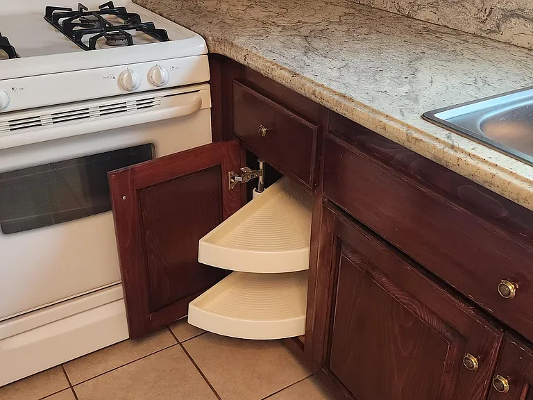 Kitchen photo with stove and Lazy Susan cabinet